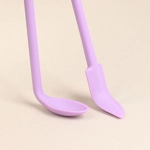 Purple silicone mini spatula and spoon set for cosmetics and jars on a beige background