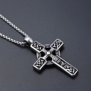 Close-up of silver stainless steel Celtic cross pendant with intricate embossed Viking pattern