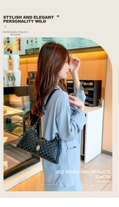 Detail of black textured leather bag with luxury gold twist lock closure for women
