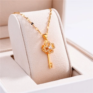 Rotating clover key pendant necklace in gold stainless steel with sparkling zircons