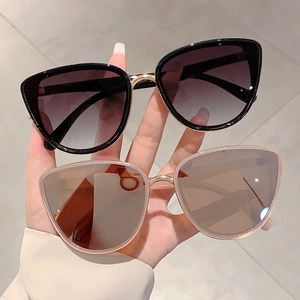 Classic cat eye sunglasses with gold metal accents and gradient lenses for women