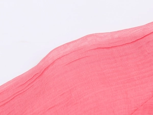 Detailed macro shot of pink pleated fabric texture with delicate ruffles for women set