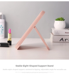 Detail of the pink folding makeup mirror showing the stable adjustable stand structure