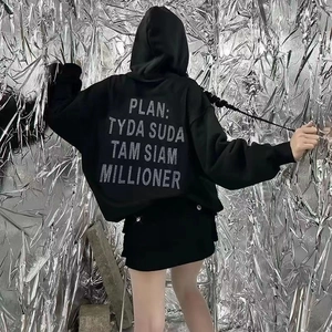 Detailed back view of oversized black hoodie with large white letter print on premium fabric