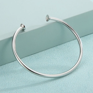 Minimalist silver stainless steel open bangle bracelet with a high-polished metallic finish