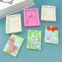 Macro shot of rectangular silicone molds and floral relief aromatherapy tablets