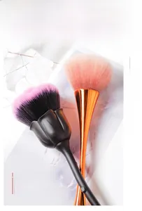 Macro detail of tulip and rose shaped makeup brushes with soft pink ombre bristles