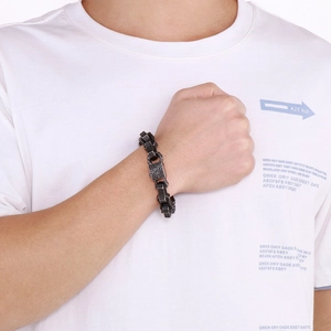 Close-up of men's vintage punk bracelet with gothic patterns on square links