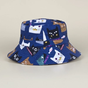 Close-up of navy canvas bucket hat with colorful cartoon cat and small fish patterns