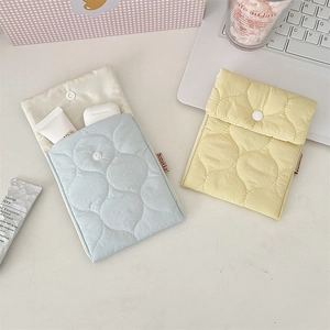 Macro view of pastel quilted mini portable organizer bags for cosmetic storage