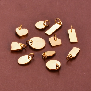 Polished gold stainless steel charms in heart, round, and oval shapes for DIY jewelry