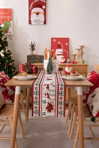Detailed view of a festive Christmas table runner with reindeer and snowflake patterns