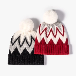 Winter knit pom-pom beanie with striped jacquard pattern and thick ribbed cuff