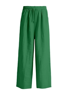 Detail of green cotton linen pants showing elastic drawstring waist and fabric texture