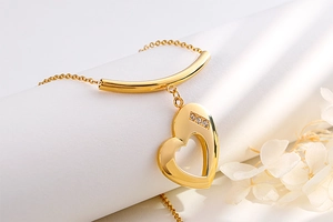 Detail view of heart necklace with small diamonds on a soft white background