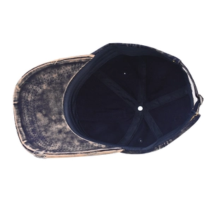 Detail view of washed denim cap showing distressed brim and inner stitching