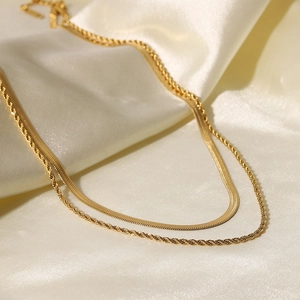 Detail of 18K gold plated double layer necklace with snake and twisted rope chain