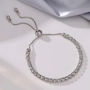 Detail of adjustable silver tennis bracelet with cubic zirconia and slide clasp closure