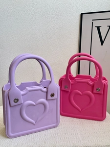 Detailed view of heart-shaped EVA beach bags in vibrant purple and magenta tones