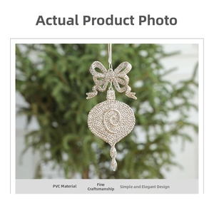 Close-up of champagne gold glitter Christmas ornament with bow and spiral PVC drop pendant