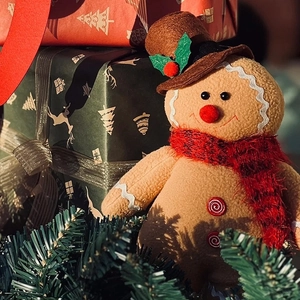 Standing Christmas plush gingerbread man with hat and red scarf for holiday decor