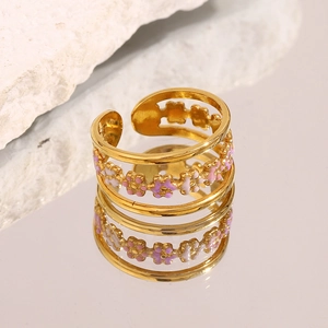 Detailed macro view of 18K gold-plated ring with pink and purple enamel flower patterns