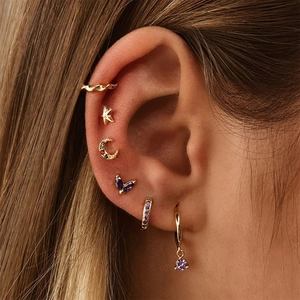 Detailed close-up of S925 silver star and crescent studs with purple stones and ear cuffs