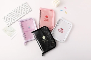 Detailed flat lay of four fruit-themed A6 transparent PVC zip binder notebooks