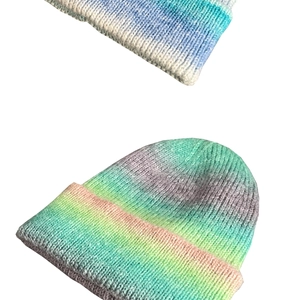 Close-up of thick knit texture and rainbow tie-dye gradient patterns on the beanie