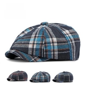 Detailed view of British style plaid newsboy cap with textured knit fabric and visor