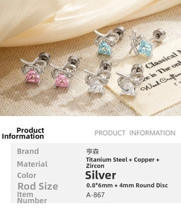 Detail of bow-shaped zircon earrings with square pink and blue stones in silver finish
