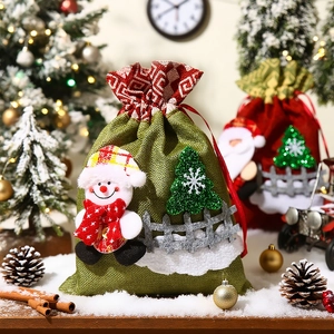 Green linen Christmas gift bag with snowman and tree appliques on a snowy scene