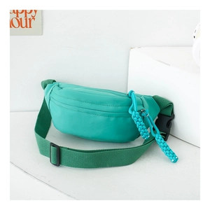 Detail of mint green nylon chest bag featuring a unique braided rope zipper puller
