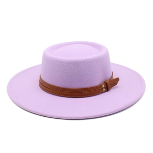 Detailed texture of lavender wool felt hat with brown leather buckle strap and wide brim