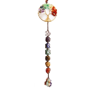 Macro detail of Tree of Life car ornament with seven chakra natural stones and tassels