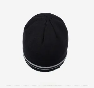 Top-down view of black thermal knit beanie with grey-white striped hem detail
