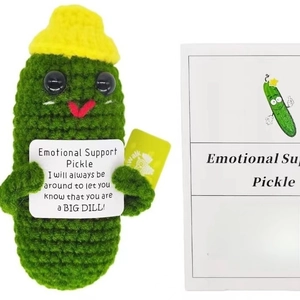 Handmade crochet emotional support pickle doll with encouragement card on white background