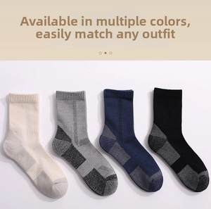 Close-up of four-color merino wool hiking socks set in white grey navy and black