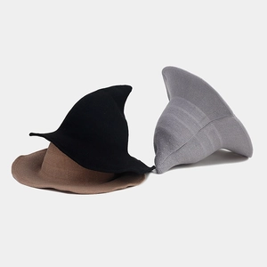 Detailed view of knitted witch hats in black, brown and grey with fine ribbed texture