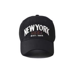Close-up of NEW YORK embroidery and USA leather patch on a cotton baseball cap