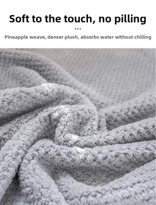 Macro detail of soft grey coral fleece towel with dense pineapple plaid texture