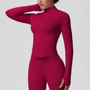 Detail of magenta seamless yoga set featuring thumbhole cuffs and ribbed knit texture
