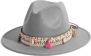 Detail of grey felt fedora featuring woven band with seashells and pink colorful tassels