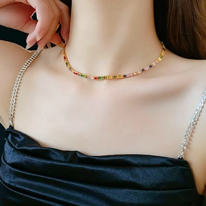 Detailed view of gold plated necklace featuring vibrant colorful zircon gemstones on neck