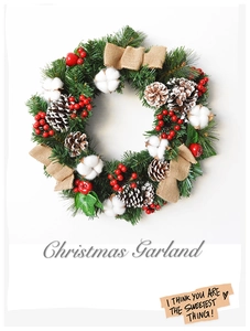 Close-up of Christmas garland with pine needles, red berries, cotton and burlap bow