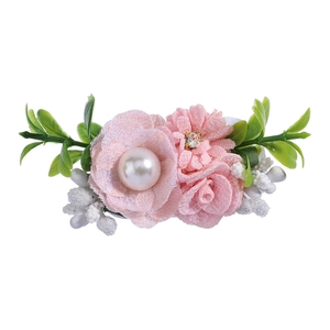 Detail of pink lace flower hair clip with white faux pearl and small rhinestone accents