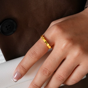 Detail of 24k gold plated geometric ring with vintage brushed texture on a model
