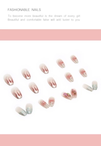 Detail of short ballet fake nails with lemon patterns, pink gradients and glitter accents