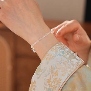 Close-up of minimalist clear crystal beaded bracelet with elegant polished round beads