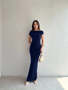 Detail of elegant ruching on the waist of a navy blue off-shoulder maxi dress